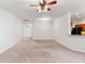 Spacious living room with neutral carpeting and a ceiling fan at 841 Greenshank Dr, Haines City, FL 33844