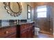 Bathroom features dark wood cabinets and a large walk-in shower at 9213 Foxhall Ct, Orlando, FL 32819