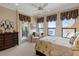 Spacious bedroom with lake views, dresser, and comfortable seating at 9213 Foxhall Ct, Orlando, FL 32819