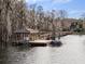 Private boat dock with covered seating area, perfect for enjoying lake views at 9213 Foxhall Ct, Orlando, FL 32819