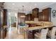 Island kitchen features granite countertops and dark wood cabinets at 9213 Foxhall Ct, Orlando, FL 32819