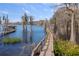 Long wooden dock extending over the lake at 9213 Foxhall Ct, Orlando, FL 32819