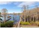 Serene boardwalk path along the lake with gazebo and trees at 9213 Foxhall Ct, Orlando, FL 32819