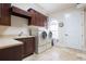 Laundry room with built-in cabinets, sink, and washer/dryer at 9213 Foxhall Ct, Orlando, FL 32819