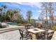 Inviting pool and patio area with fire pit and lake views at 9213 Foxhall Ct, Orlando, FL 32819