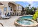 Resort-style pool and spa with outdoor kitchen and seating area at 9213 Foxhall Ct, Orlando, FL 32819