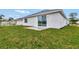 Rear view of house with sliding glass doors and grassy yard at 925 Magnolia Ave, Holly Hill, FL 32117