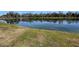 Tranquil lake view with grassy shoreline at 925 Magnolia Ave, Holly Hill, FL 32117