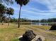 Peaceful lakefront property with palm trees at 925 Magnolia Ave, Holly Hill, FL 32117