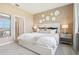 Spacious bedroom with a king-size bed and an accent wall at 9544 Starling Loop, Leesburg, FL 34788