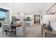 Bright dining room with a wood table and modern chairs, open to the kitchen at 9556 Starling Loop, Leesburg, FL 34788