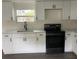 Modern kitchen with white cabinets and black appliances at 9868 6Th Ave, Orlando, FL 32824