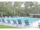 Community swimming pool with lounge chairs and covered area at 10 Moree Loop # 1, Winter Springs, FL 32708