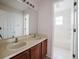 Bright bathroom features a double sink vanity and a separate tub and shower at 1010 Embrun Ct, Kissimmee, FL 34759