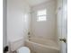 Clean bathroom with a bathtub, shower and a window for natural light at 1010 Embrun Ct, Kissimmee, FL 34759