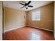 Bedroom with wood floors, tan walls, a window, and a ceiling fan at 1010 Embrun Ct, Kissimmee, FL 34759