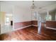 Dining room featuring hardwood floors and view into the main entrance and staircase at 1010 Embrun Ct, Kissimmee, FL 34759