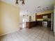 A combined kitchen/dining area featuring a tile floor and a breakfast bar at 1010 Embrun Ct, Kissimmee, FL 34759