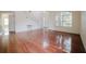 Open-concept living room with hardwood floors, staircase, and large window at 1010 Embrun Ct, Kissimmee, FL 34759