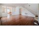 Large living room with hardwood floors, columns, and view into another room at 1010 Embrun Ct, Kissimmee, FL 34759