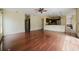 Spacious living room with wood floors and a ceiling fan leading into the kitchen at 1010 Embrun Ct, Kissimmee, FL 34759