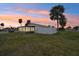 Backyard with a screened enclosure at sunset at 106 Cardinal Dr # D, Ormond Beach, FL 32176