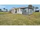 Side view of the house showcasing the screened porch and lawn at 106 Cardinal Dr # D, Ormond Beach, FL 32176