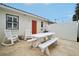 Relaxing patio with white picnic table and rocking chairs at 106 Cardinal Dr # D, Ormond Beach, FL 32176