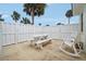 Fenced patio with a white picnic table and rocking chair at 106 Cardinal Dr # D, Ormond Beach, FL 32176