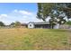 Backyard view of house, grassy area, and trees at 1062 Blue Horizon Dr, Deltona, FL 32725