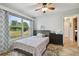 Bedroom with double bed, large window, and ceiling fan at 1062 Blue Horizon Dr, Deltona, FL 32725