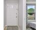 Bright entryway with white door and view to a bedroom at 1062 Blue Horizon Dr, Deltona, FL 32725