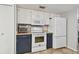 Modern kitchen with white appliances and dark cabinets at 1062 Blue Horizon Dr, Deltona, FL 32725