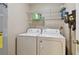 Bright laundry room, washer, dryer, and shelving for storage at 1062 Blue Horizon Dr, Deltona, FL 32725