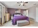 Main bedroom with purple bedding and ceiling fan at 1062 Blue Horizon Dr, Deltona, FL 32725