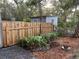 Landscaped backyard with wood fence and shed at 113 W 19Th St, Sanford, FL 32771