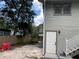 Home exterior featuring wood paneling, stairs to the upper level, and a fenced yard at 113 W 19Th St, Sanford, FL 32771