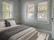 Neutral bedroom with large windows, bed, and light wood floors at 113 W 19Th St, Sanford, FL 32771