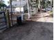 Gravel driveway with gate and chain link fence at 113 W 19Th St, Sanford, FL 32771