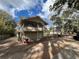 Angled view of home with screened porch and fenced in yard at 113 W 19Th St, Sanford, FL 32771