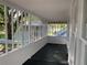 Screened porch with dark stained floors and view of the yard at 113 W 19Th St, Sanford, FL 32771