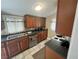 Cozy kitchen features wood cabinets, dark countertops, and stainless steel appliances at 113 W 19Th St, Sanford, FL 32771