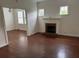 Living room with hardwood floors and brick fireplace at 113 W 19Th St, Sanford, FL 32771