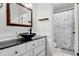 Bathroom with black vessel sink, white vanity, and marble shower curtain at 1234 Villa Ln # 142, Apopka, FL 32712