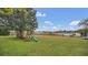 Large backyard with playground set overlooking lake at 1296 W Wellington Dr, Deltona, FL 32725