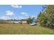 Kayaks and a dock sit on the grassy lakeside backyard at 1296 W Wellington Dr, Deltona, FL 32725