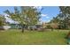 Spacious backyard with patio, shade sail, and grassy area at 1296 W Wellington Dr, Deltona, FL 32725