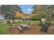 Large backyard with shade sail, picnic table, playset, and cornhole at 1296 W Wellington Dr, Deltona, FL 32725