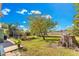 Landscaped backyard with lake view and patio at 1296 W Wellington Dr, Deltona, FL 32725