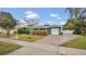 House exterior showing a brick driveway and green lawn at 1296 W Wellington Dr, Deltona, FL 32725